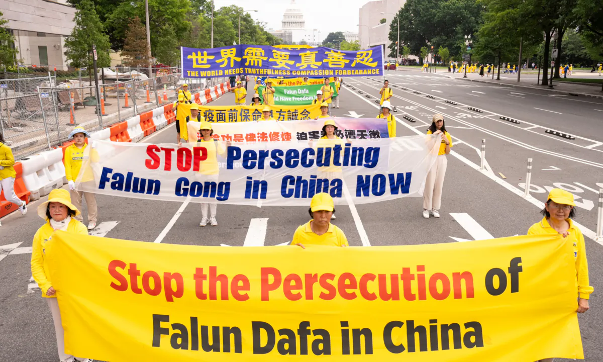 Falun Gong adherents take part in a march to mark the 24th anniversary of the persecution of the spiritual discipline in China by the Chinese Communist Party at the National Mall in Washington on July 20, 2023. (Larry Dye/The Epoch Times)