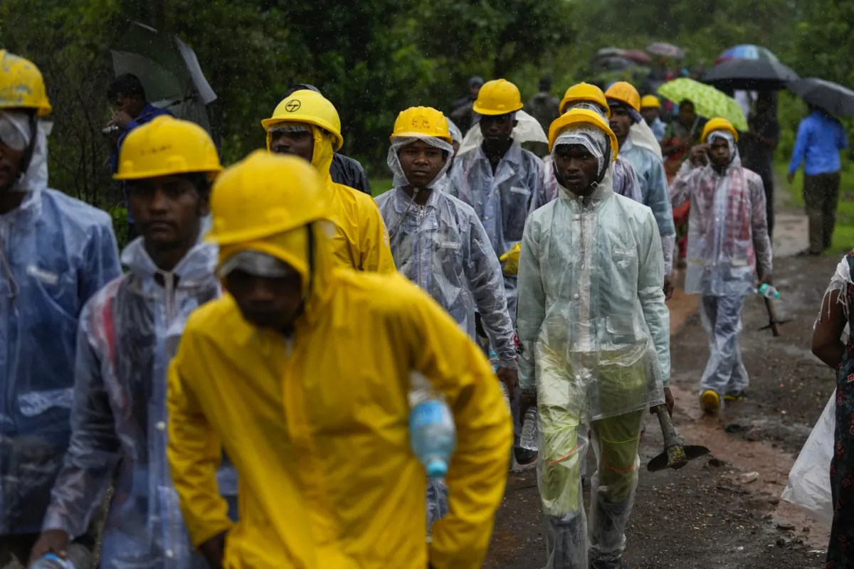 Rescuers walk towards the site of a landslide in Raigad district, western Maharashtra state, India, on July 20, 2023. (Rafiq Maqbool/AP Photo)