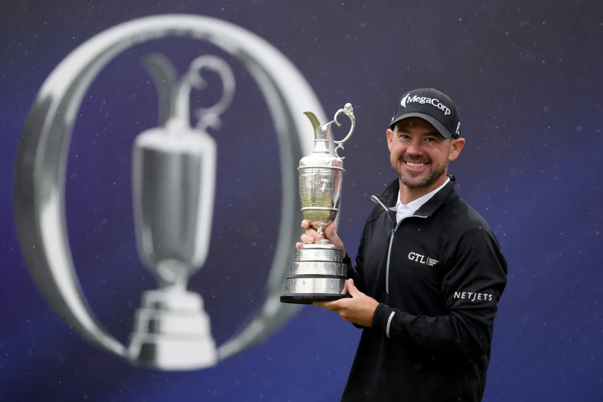 Brian Harman of the United States poses for a photograph with the Claret Jug on the 18th green after winning on Day Four of The 151st Open at Royal Liverpool Golf Club in Hoylake, England, on July 23, 2023. (Warren Little/Getty Images)