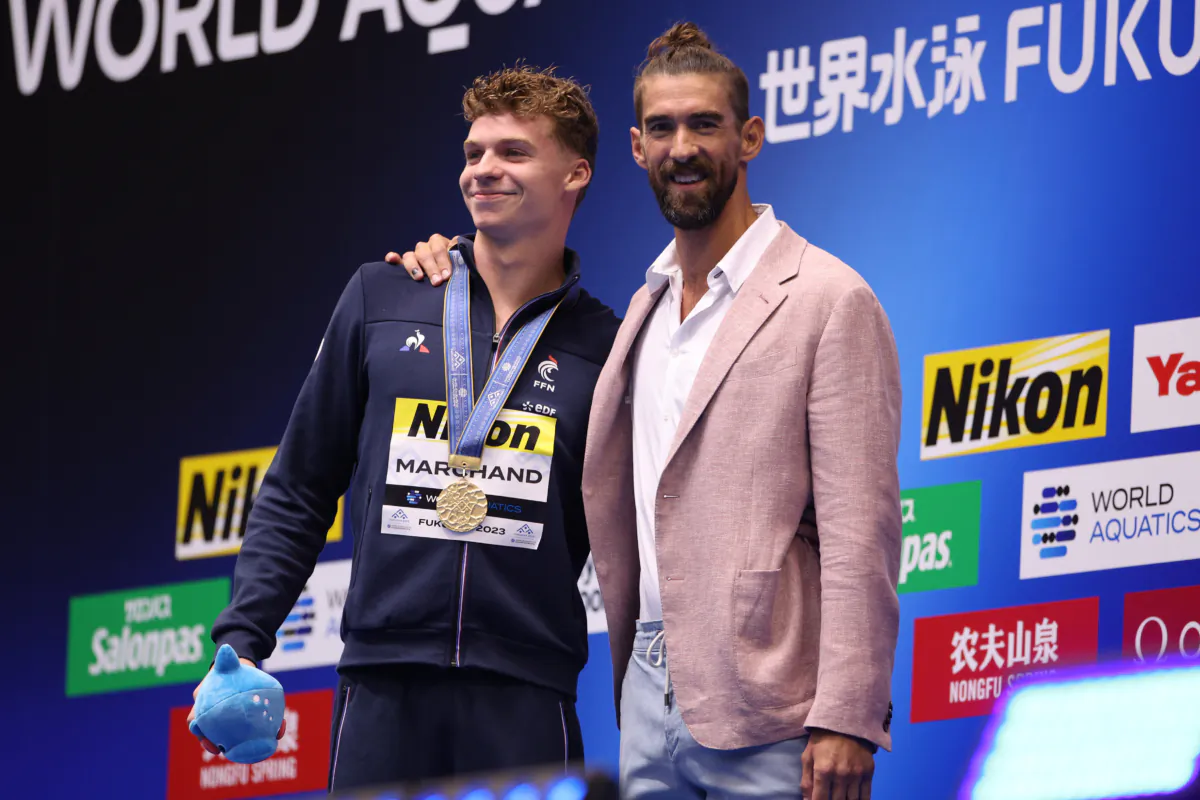 Gold medallist Leon Marchand of Team France (L) is congratulated by Michael Phelps during the medal ceremony for the Men's 400m Individual Medley Final on day one of the Fukuoka 2023 World Aquatics Championships at Marine Messe Fukuoka Hall A in Fukuoka, Japan, on July 23, 2023. (Adam Pretty/Getty Images)