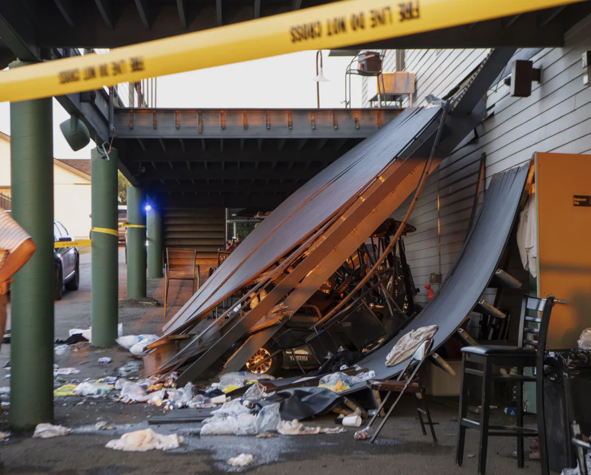 Police tape is wrapped around the scene of a deck collapse at Briarwood Country Club in Billings, Mont., on July 23, 2023. (Amy Lynn Nelson/The Billings Gazette via AP)