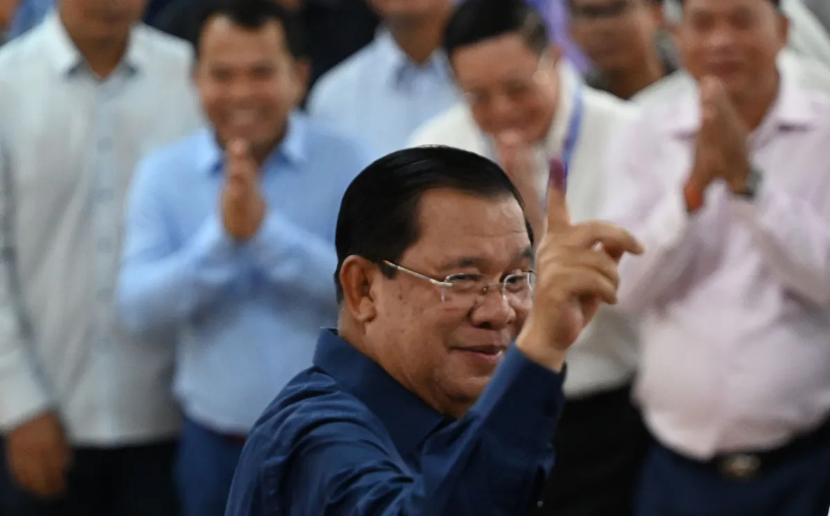 Cambodia's Prime Minister Hun Sen displays his marked finger to show he has cast his vote at a polling station in Kandal province during the general elections on July 23, 2023. (TANG CHHIN SOTHY/AFP via Getty Images)