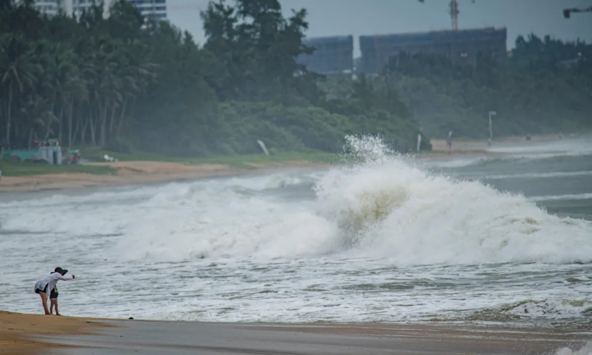 People watch big waves at a sea shore as Typhoon Talim approaches in Boao, in China's southern Hainan province, on July 17, 2023. (CNS/AFP via Getty Images)