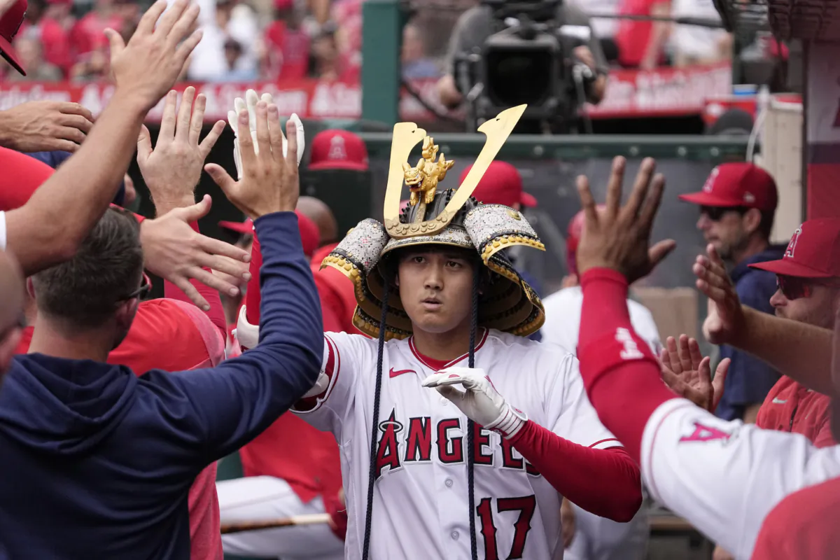 Los Angeles Angels' Shohei Ohtani is congratulated by teammates in the dugout after hitting a solo home run during the first inning of a baseball game against the Pittsburgh Pirates in Anaheim, Calif., on July 23, 2023 (Mark J. Terrill/AP Photo)
