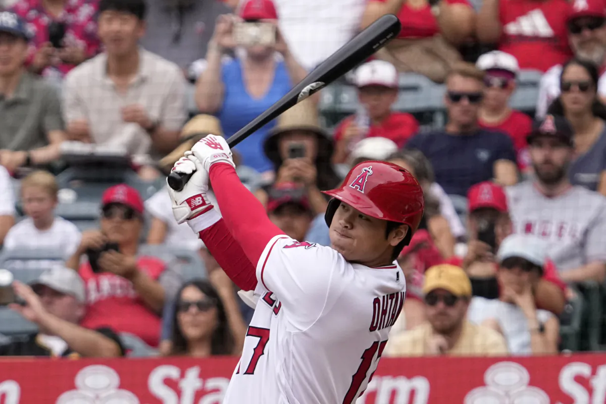 Los Angeles Angels' Shohei Ohtani follows through as he hits a solo home run during the first inning of a baseball game against the Pittsburgh Pirates in Anaheim, Calif., on July 23, 2023 (Mark J. Terrill/AP Photo)