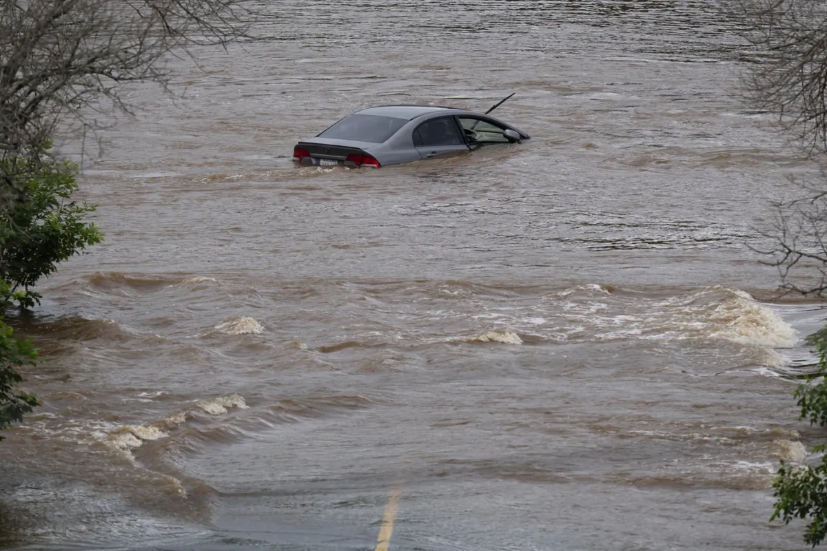 An abandoned car in a mall parking lot is seen in floodwater following a major rain event in Halifax on July 22, 2023. (The Canadian Press/Darren Calabrese)