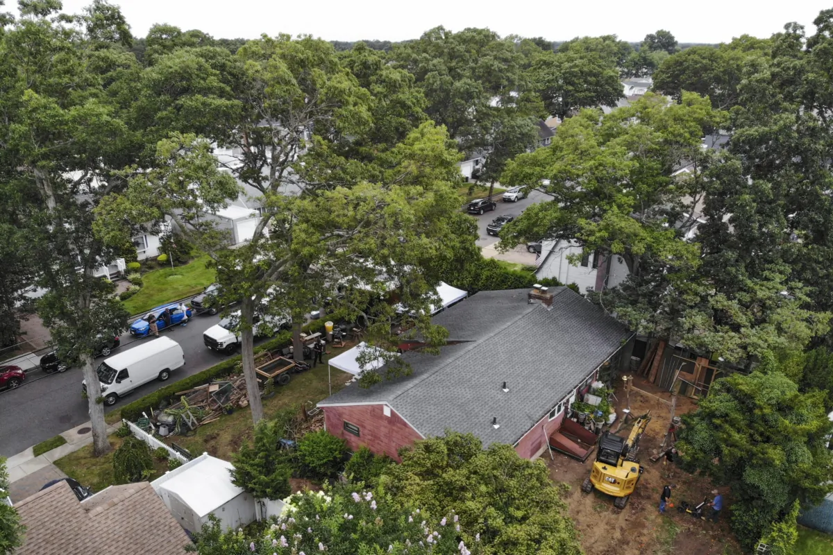 Authorities continue to work at the home of suspect Rex Heuermann (bottom R) in Massapequa Park, N.Y., on July 24, 2023. (Seth Wenig/AP Photo)