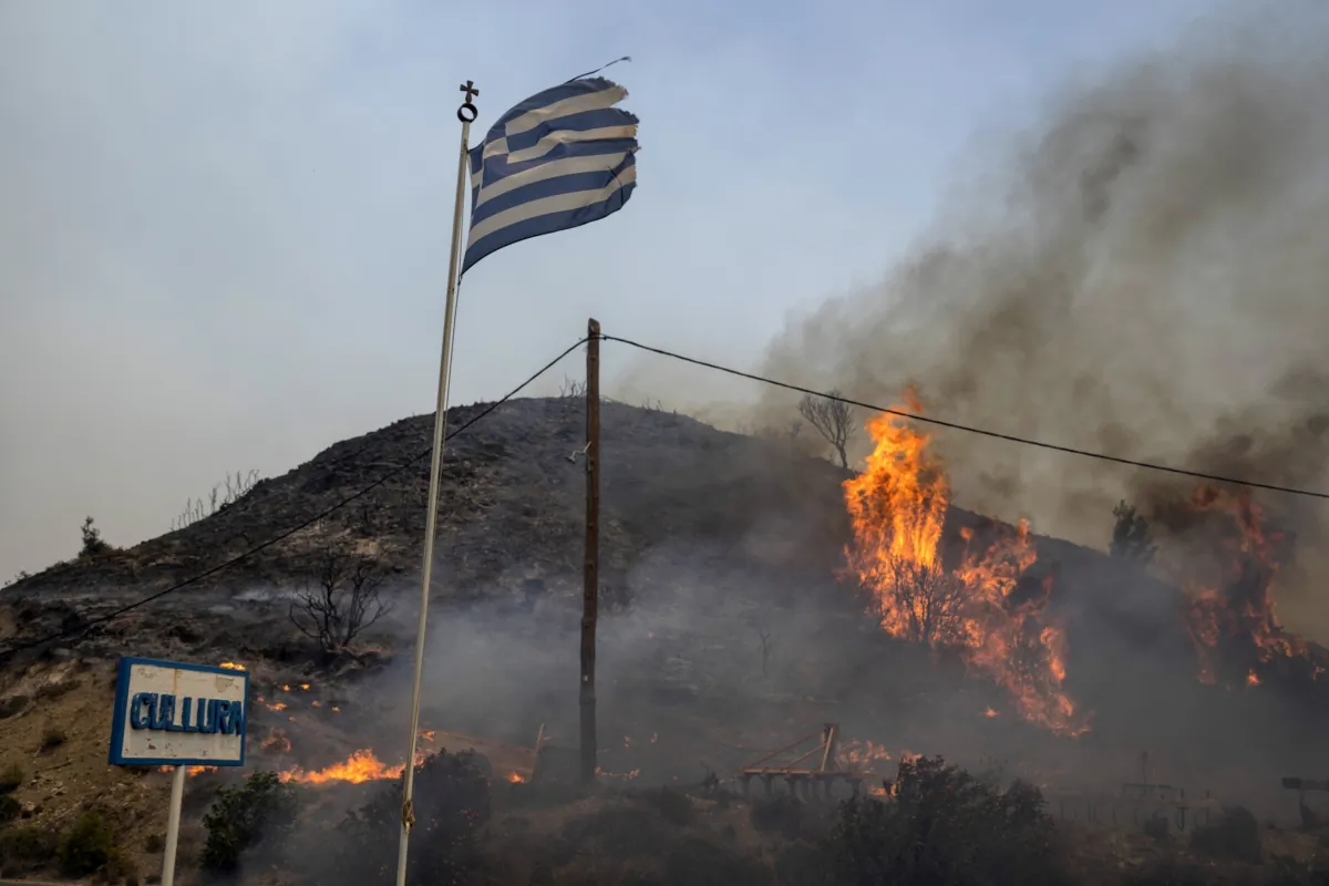 Flames burn a hill on the Aegean Sea island of Rhodes, southeastern Greece, on July 24, 2023. (Petros Giannakouris/AP Photo)