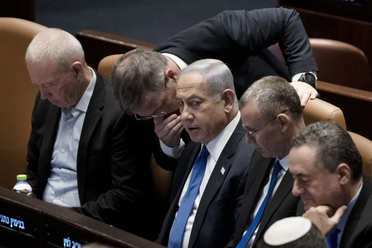 Lawmakers surround Israel's Prime Minister Benjamin Netanyahu (C) at a session of the Knesset, Israel's parliament, in Jerusalem on July 24, 2023. (Maya Alleruzzo/AP Photo)