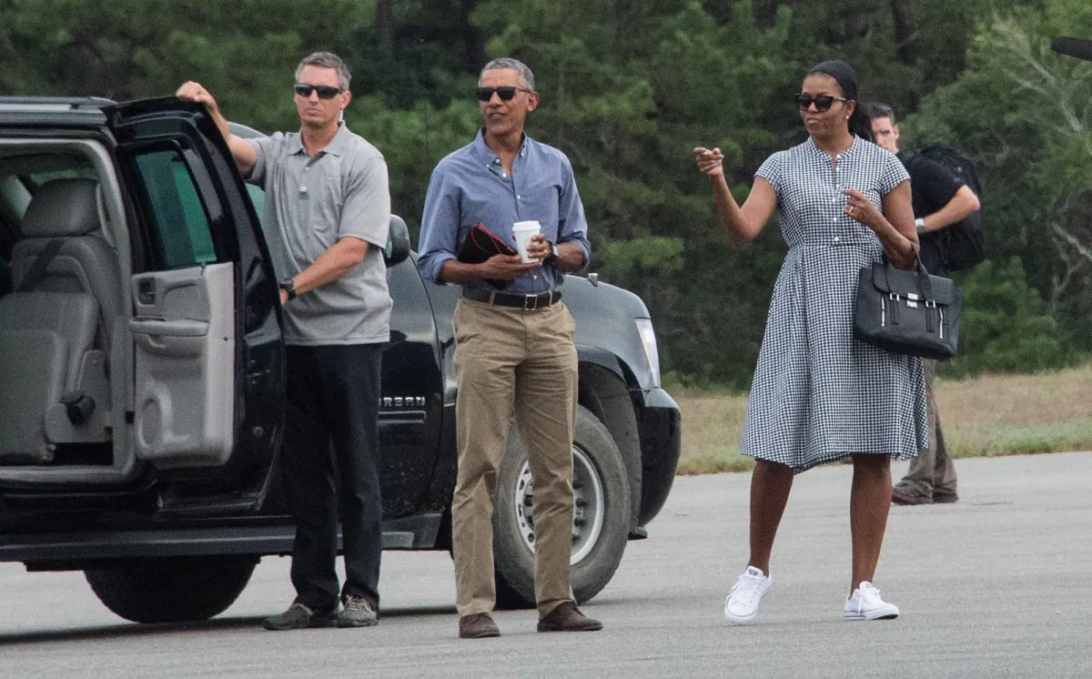 U.S. President Barack Obama and First Lady Michelle Obama wait for their daughters Malia and Sasha to board Marine One at Martha's Vineyard airport in Edgartown, Mass., on August 21, 2016. (Nicholas Kamm/AFP via Getty Images)