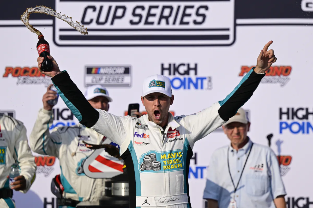Denny Hamlin celebrates in Victory Lane after winning a NASCAR Cup Series auto race at Pocono Raceway in Long Pond, Pa., on July 23, 2023. (Derik Hamilton/AP Photo)