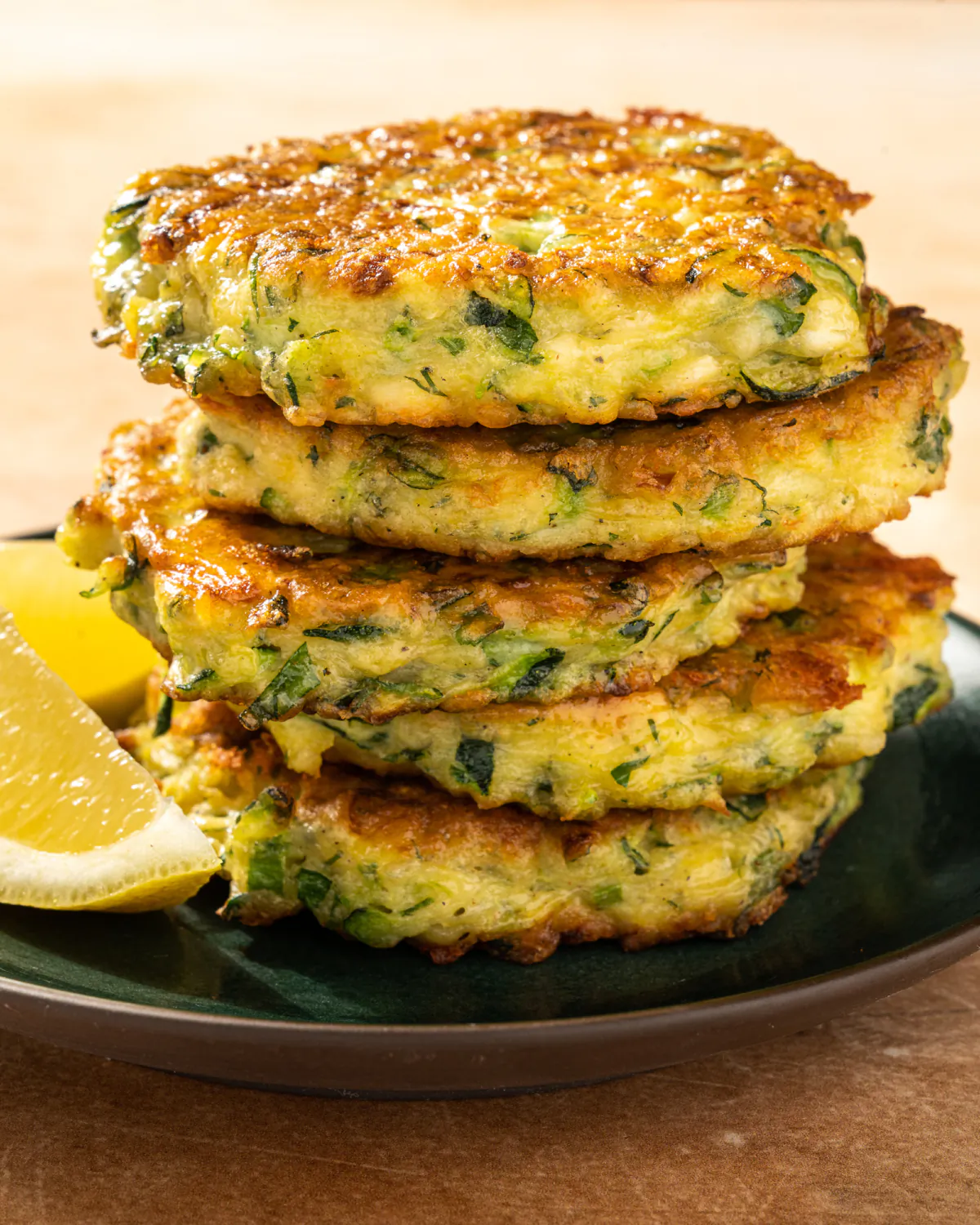 These fluffy, savory pancakes are packed with shredded zucchini, herbs and salty bites of feta cheese. (Kristina Vanni/TNS)