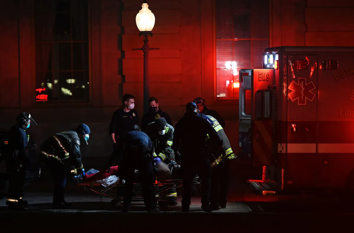 Paramedics perform cardiopulmonary resuscitation on Rosanne M. Boyland outside the Law Library entrance of the U.S. Capitol on Jan. 6, 2021. (Andrew Caballero-Reynolds/AFP via Getty Images)