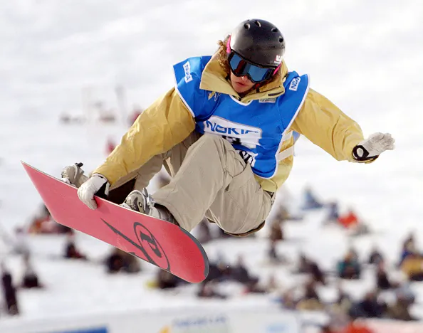 Lindsey Jacobellis performs in the air during her World Cup snowboarding half-pipe competition in the Joetsu-Kokusai ski area in Shiozawa, Niigata prefecture on Feb. 28, 2004. (JIJI PRESS/AFP via Getty Images)