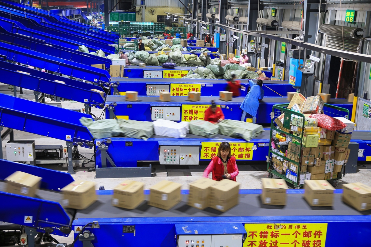 Workers sort out packages at a delivery company a day after "Singles' Day", the world's biggest 24-hour shopping event, in Hengyang in China's central Hunan Province early on Nov. 12, 2019. (STR/AFP via Getty Images)