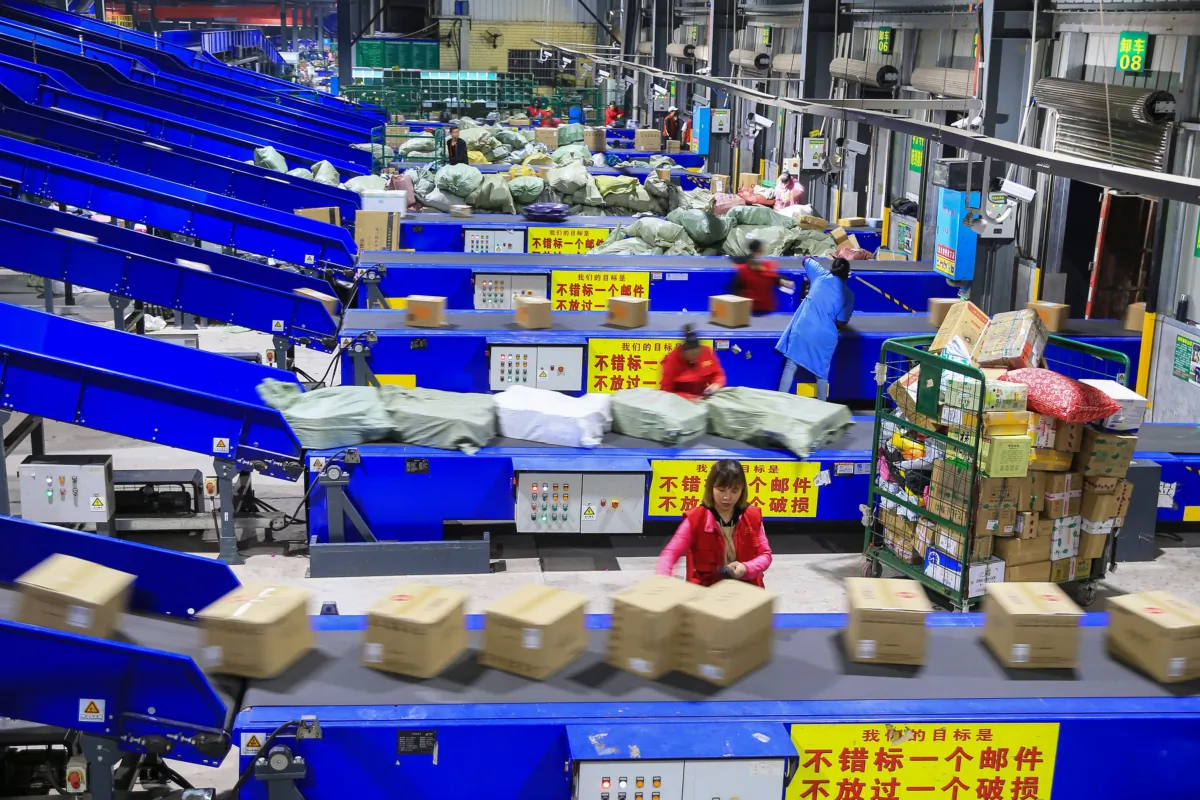 Workers sort out packages at a delivery company a day after Singles' Day—the world's biggest 24-hour shopping event—in Hengyang, in China's central Hunan Province, on Nov. 12, 2019. (STR/AFP via Getty Images)