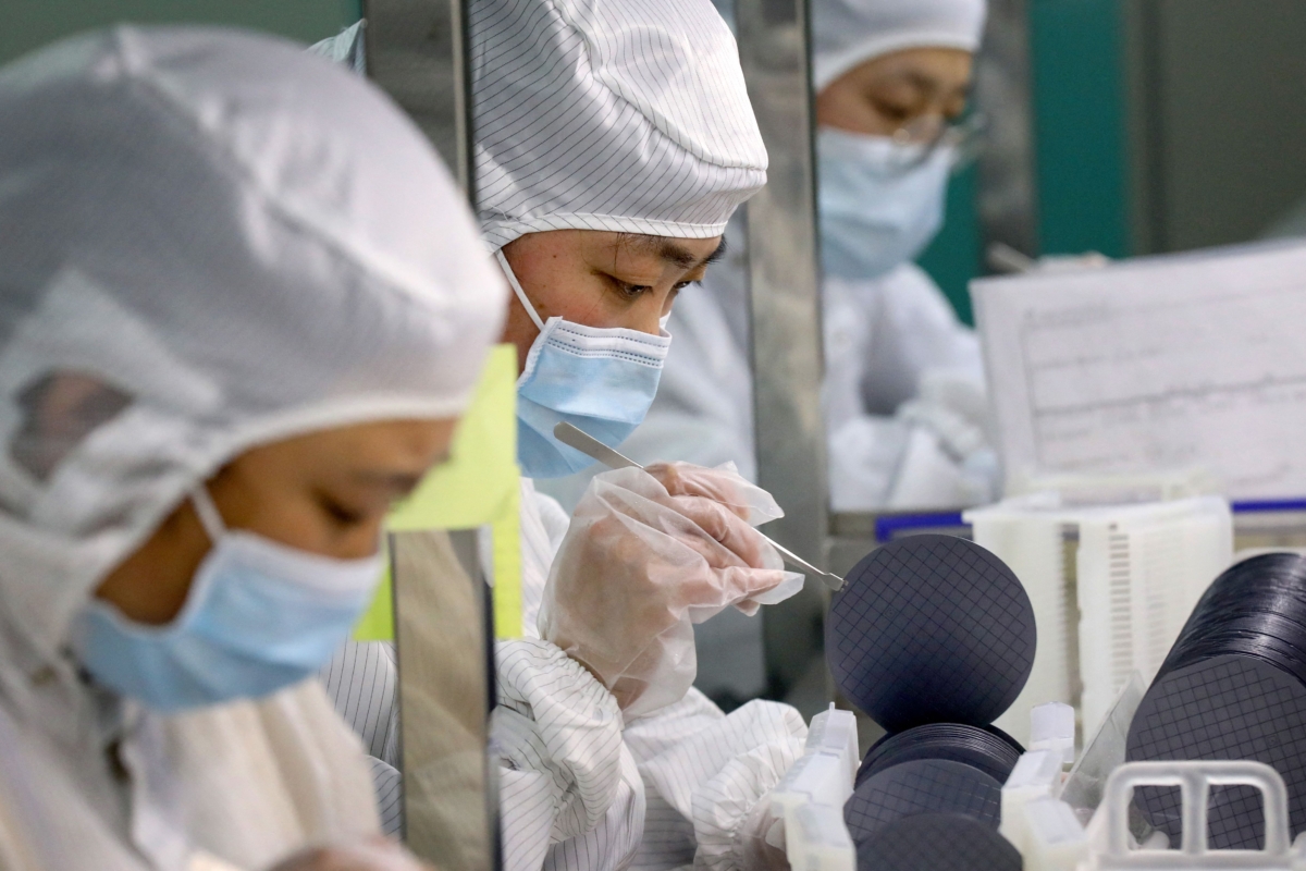 Employees make chips at a factory of Jiejie Semiconductor Company in Nantong, in eastern China's Jiangsu Province, on March 17, 2021. (STR/AFP via Getty Images)