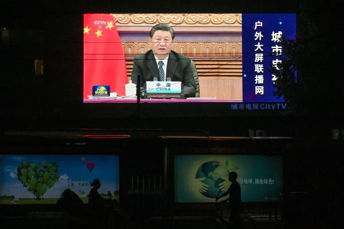 A large screen shows a news program featuring Chinese leader Xi Jinping speaking via video at the opening of the virtual BRICS Summit being hosted by India, on a street in Beijing on Sept. 10, 2021. (Greg Baker/AFP via Getty Images)