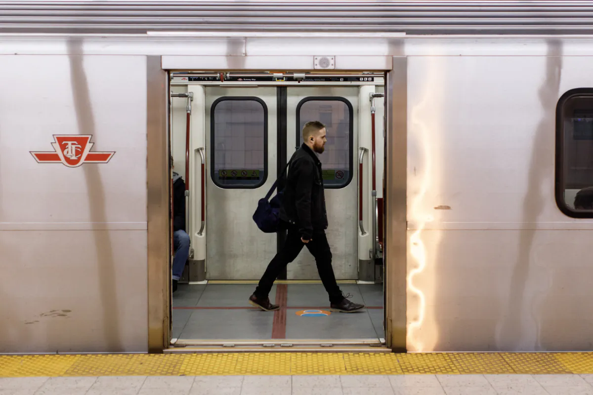 A rider takes a subway train at a Toronto Transit Commission station in downtown Toronto on April 1, 2023. (Cole Burston/The Canadian Press)