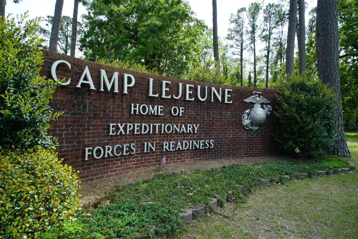 Signage stands on the main gate to Camp Lejeune Marine Base outside Jacksonville, N.C., on April 29, 2022. Three men who were found dead over the weekend at an eastern N.C. gas station have been identified as Marine lance corporals stationed nearby at Camp Lejeune, the U.S. Marine Corps said July 25, 2023. (Allen G. Breed/AP Photo)