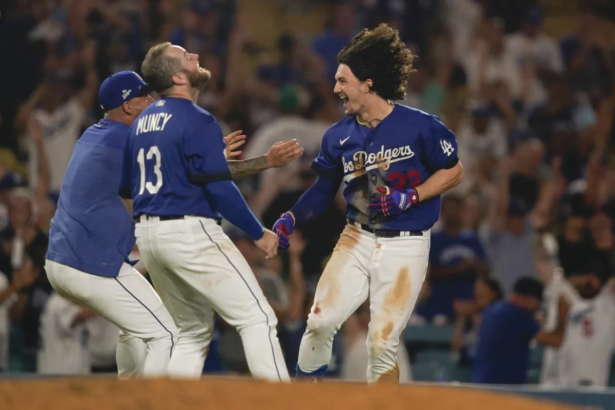 Los Angeles Dodgers' James Outman, right, celebrates with Max Muncy (13) after Outman drove in the winning run with a double against the the Toronto Blue Jays during the 10th inning of a baseball game in Los Angeles on July 25, 2023. (Ryan Sun/AP Photo)