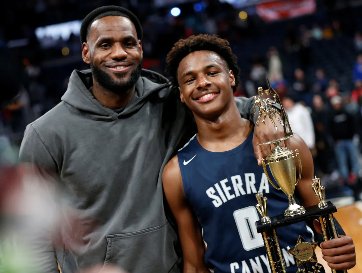 LeBron James (L), poses with his son Bronny after Sierra Canyon beat Akron St. Vincent - St. Mary in a high school basketball game in Columbus, Ohio, on Dec. 14, 2019. (Jay LaPrete/AP Photo)