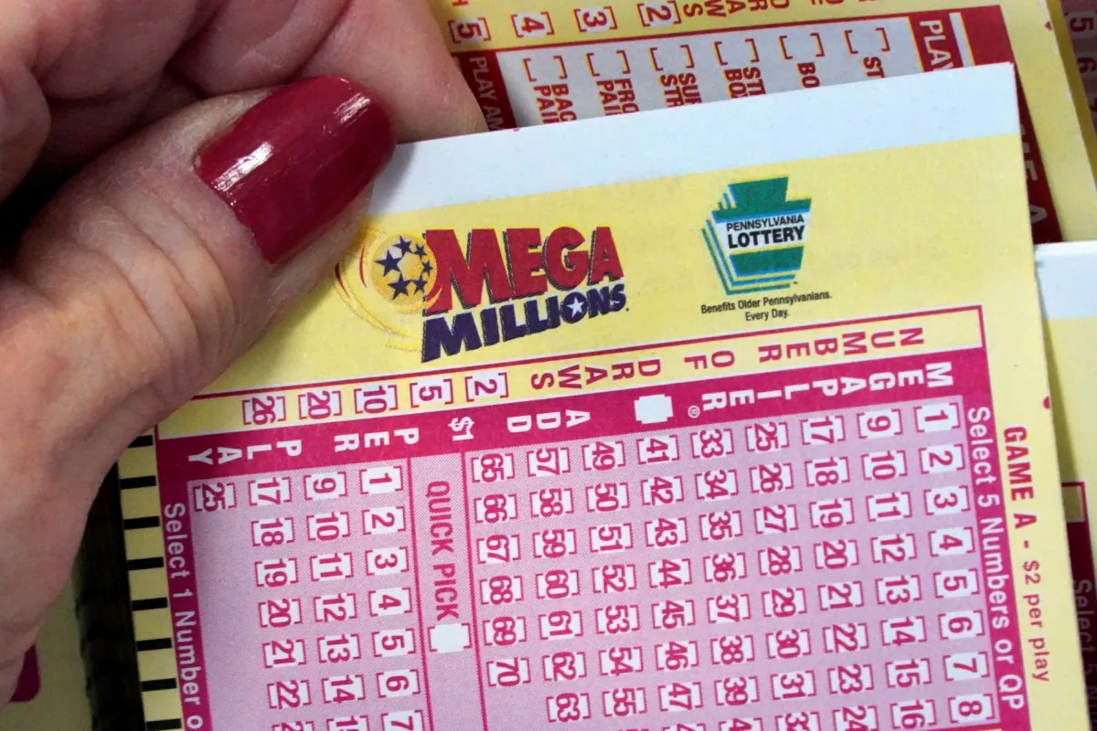 A Mega Millions wagering slip is held in Cranberry Township, Pa., on Jan. 12, 2023. (Gene J. Puskar/AP Photo)