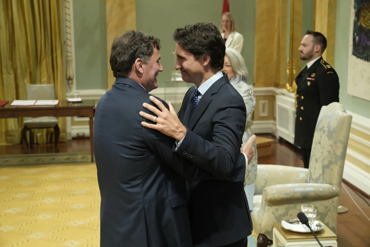 Prime Minister Justin Trudeau hugs Minister of Public Safety, Democratic Institutions and Intergovernmental Affairs Dominic LeBlanc during a cabinet swearing-in ceremony at Rideau Hall in Ottawa on July 26, 2023. (Adrian Wyld/The Canadian Press)
