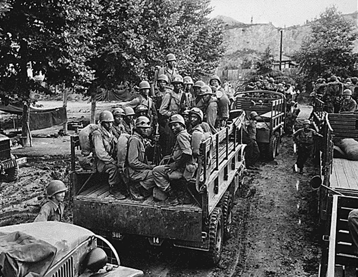 Men of the U.S. Army 24th Infantry Regiment loaded on trucks for transport up to the firing line during the Korean War on July 18, 1950. (National Archives/AFP via Getty Images)