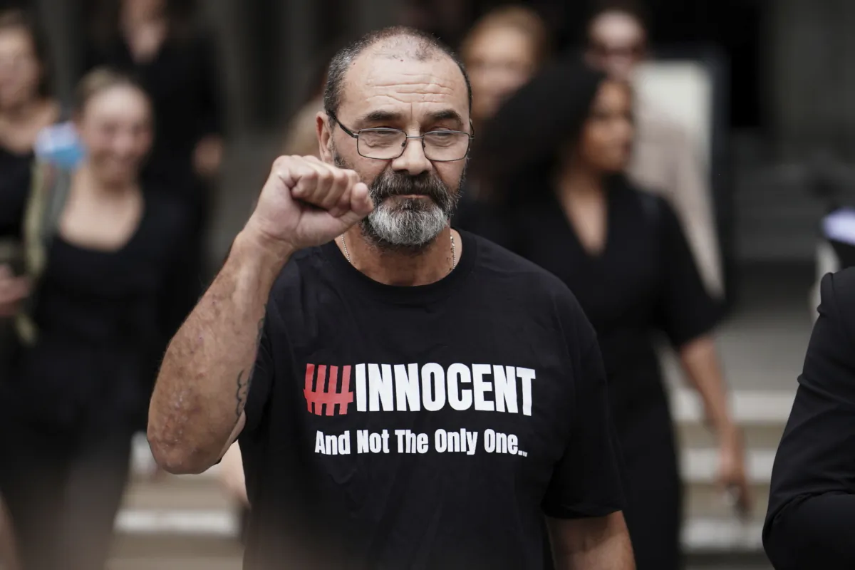 Andrew Malkinson raises a fist outside the Royal Courts of Justice in London on July 26, 2023. (Jordan Pettitt/PA via AP)