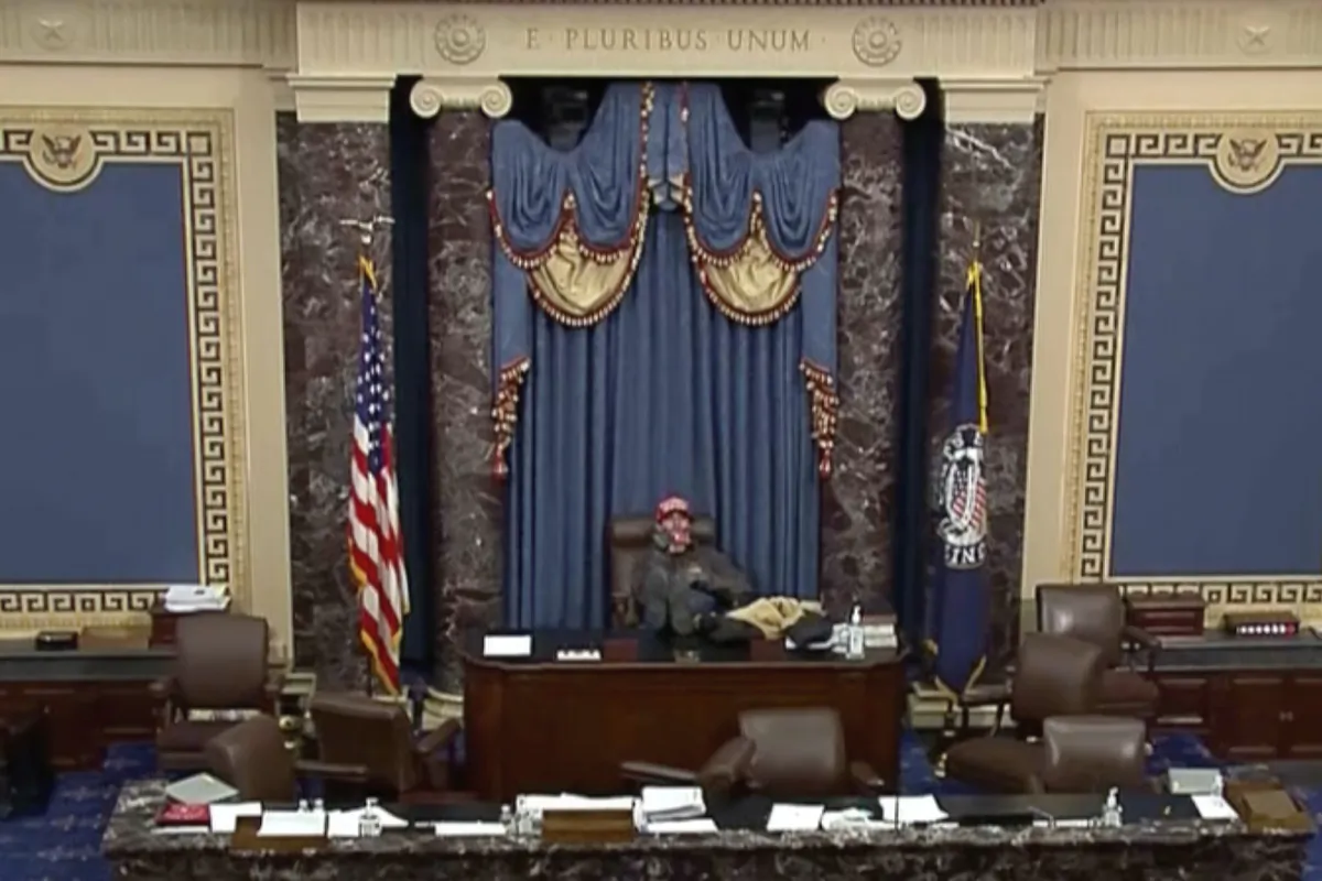 This image from U.S. Senate video, introduced at the trial of Bruno Joseph Cua, shows Mr. Cua sitting with his feet up in the Senate chamber on Jan. 6, 2021. (Senate Television via AP)