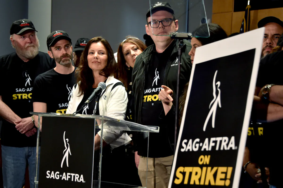 SAG-AFTRA President actress Fran Drescher, SAG-AFTRA secretary-treasurer actress Joely Fisher, and National Executive Director and Chief Negotiator Duncan Crabtree-Ireland, joined by SAG-AFTRA members, hold a press conference at the labor union's headquarters in Los Angeles on July 13, 2023. (Chris Delmas/AFP via Getty Images)