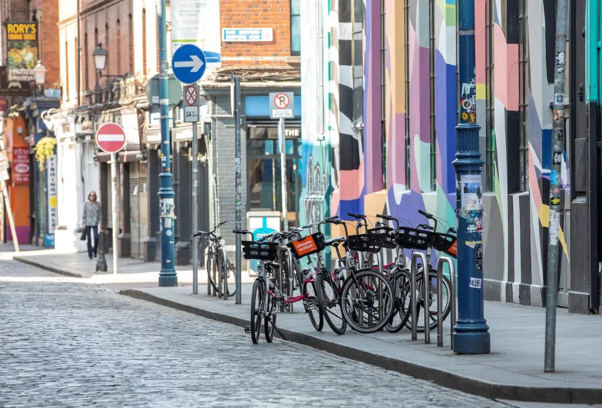 A woman walks along the empty streets of the Temple Bar district of Dublin, on March 25, 2020. (Paul Faith/AFP via Getty Images)