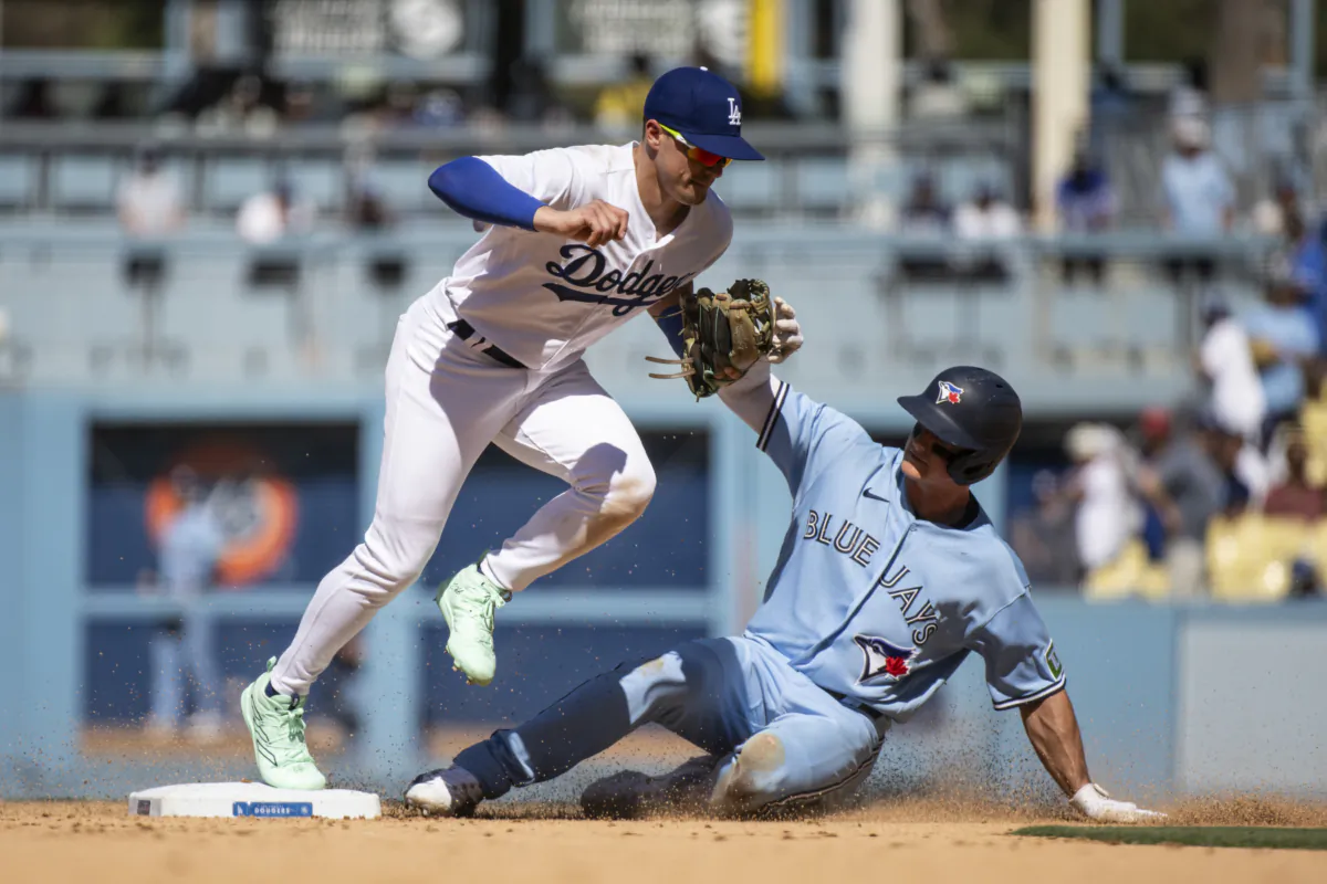 Los Angeles Dodgers second baseman Kike Hernandez, left, forces out Toronto Blue Jays' Matt Chapman during the ninth inning of a baseball game in Los Angeles on July 26, 2023. (Kyusung Gong/AP Photo)