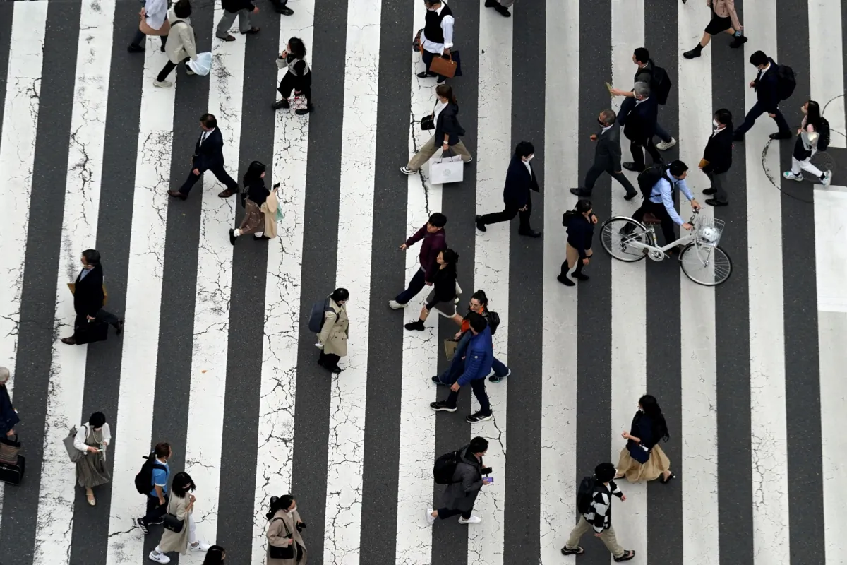 People walk along a pedestrian crossing at Ginza shopping street in Tokyo, Japan, on March 31, 2023. (Eugene Hoshiko/AP Photo)