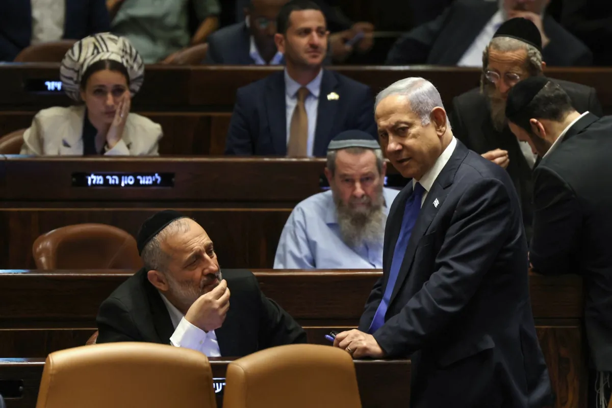 Israel's Prime Minister Benjamin Netanyahu (R) speaks with Aryeh Deri (L), chairman of Orthodox party Shas, during a parliament session in Jerusalem on July 24, 2023. (Ronaldo Schemidt/AFP via Getty Images)