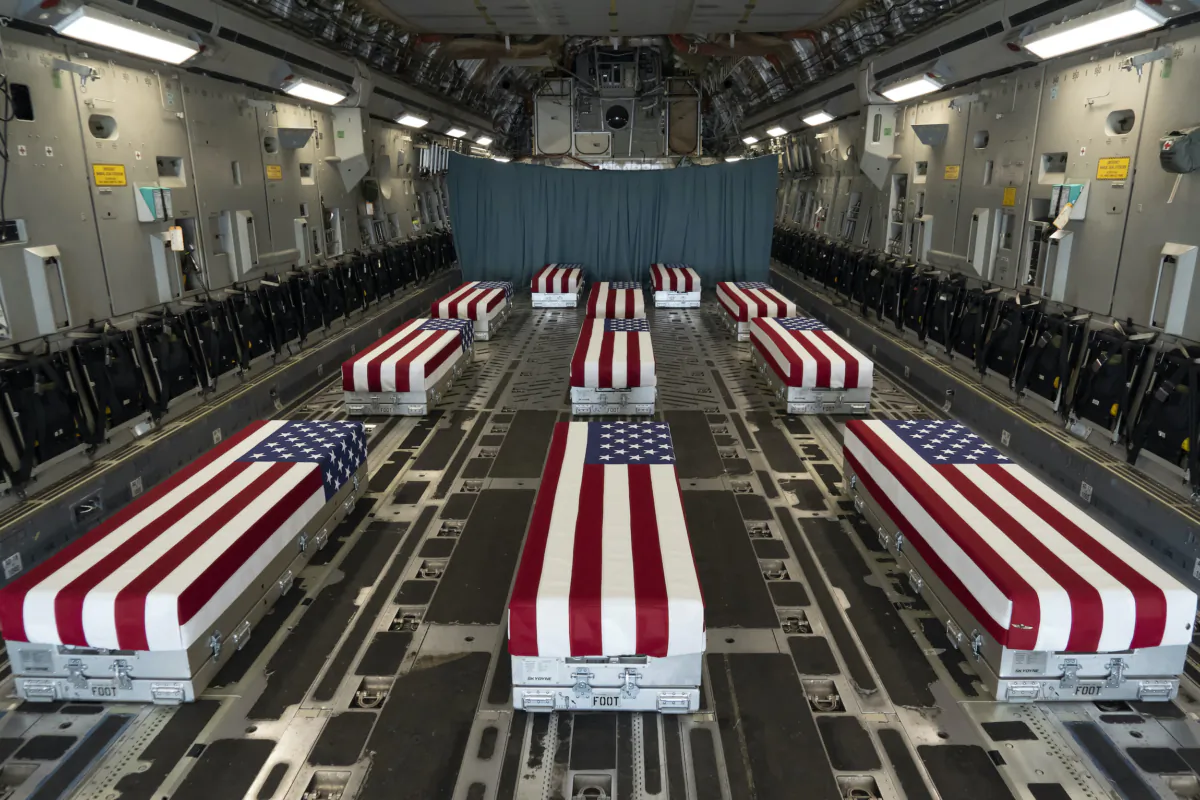 Flag-draped transfer cases line the inside of a C-17 Globemaster II on Aug. 29, 2021, prior to a dignified transfer at Dover Air Force Base, Del. The fallen service members died while supporting non-combat operations in Kabul. (U.S. Air Force photo by Jason Minto)