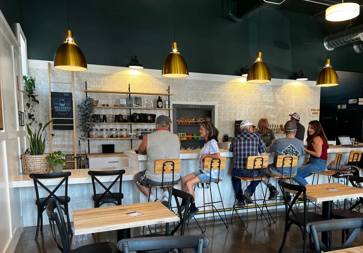 Customers sit at the bar top of Brethren Brewing Company Friday, June 30, 2023. (Dominique Williams/The Modesto Bee/TNS)