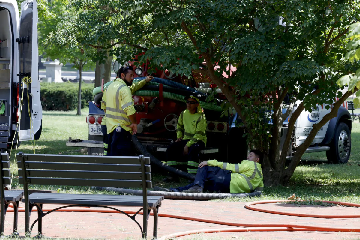 Construction workers rest in the shade during maintenance work in Lafayette Park on July 27, 2023 in Washington, DC. (Anna Moneymaker/Getty Images)