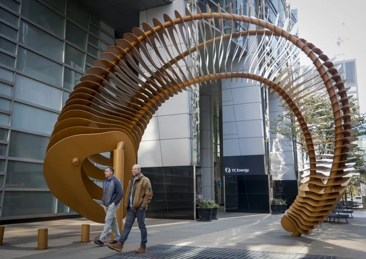 Pedestrians walk past a sculpture outside the TC Energy head office in downtown Calgary, Alta., Sept. 16, 2022. (The Canadian Press/Jeff McIntosh)
