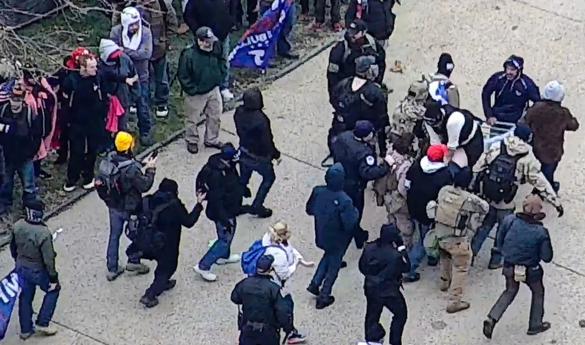 A group of protesters carries Benjamin J. Philips on a makeshift gurney after paramedics refused to come to where he collapsed near the U.S. Capitol on Jan. 6, 2021. (U.S. Capitol Police/Screenshot via The Epoch Times)