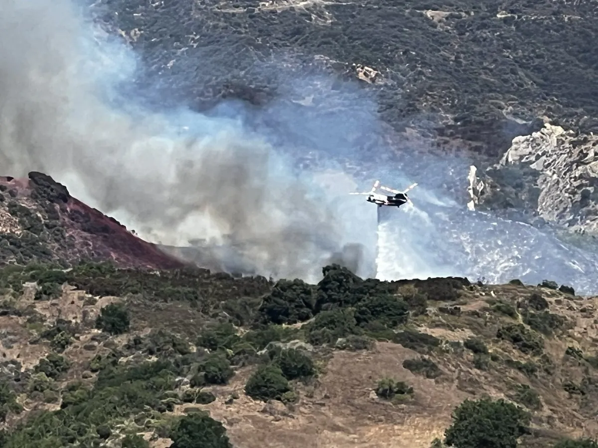 Firefighters drop water on the Owen fire in the Santa Monica Mountains, Calif., on July 26, 2023. (Courtesy of Dave Egerstrom)