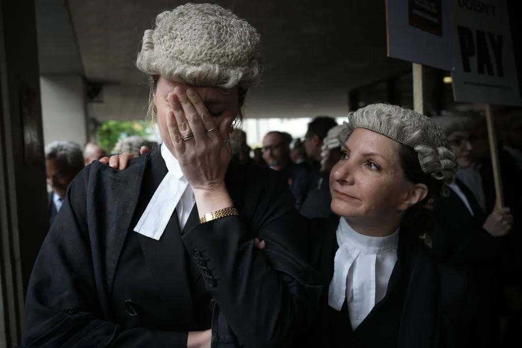 Barristers become emotional after listening to speeches during a protest over funding outside Manchester Crown Court on June 27, 2022. (Photo by Christopher Furlong/Getty Images)