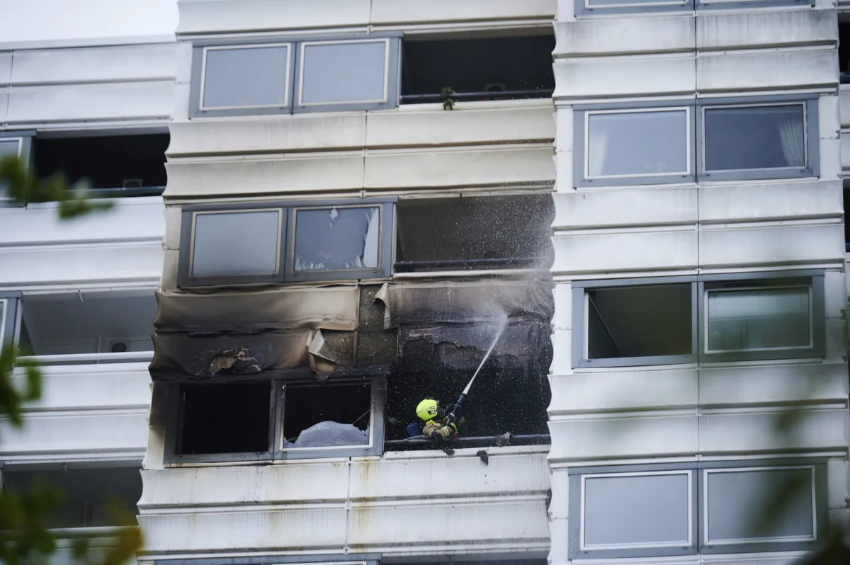 A firefighter extinguishes a fire in a building in Berlin on July 28, 2023. (Annette Riedl/dpa via AP)