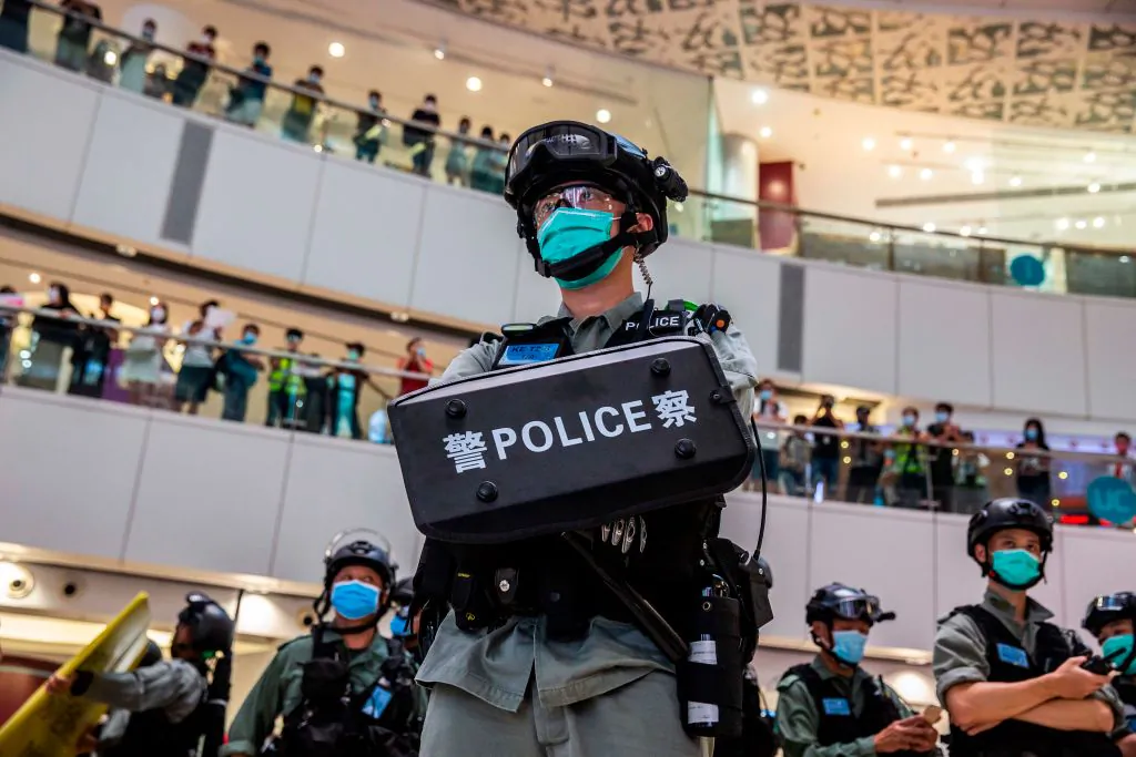 A riot police officer (C) stands guard during a clearance operation during a demonstration in a mall in Hong Kong on July 6, 2020, in response to a new national security law introduced in the city that makes political views, slogans, and signs advocating Hong Kong's independence or liberation illegal. (Isaac Lawrence/AFP via Getty Images)
