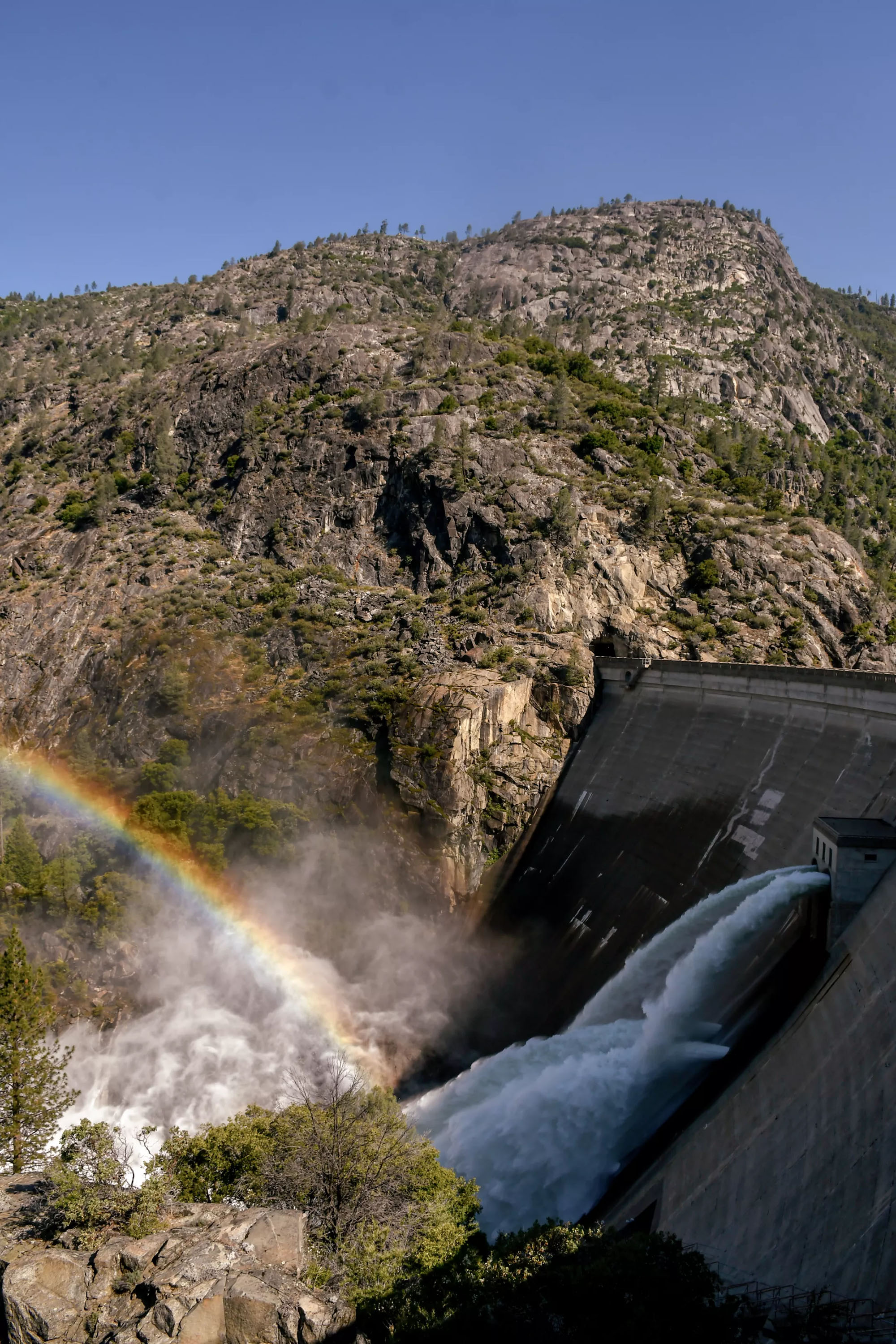 From the Hetch Hetchy Valley’s O’Shaughnessy Dam, the Tuolumne River flows into the San Joaquin Valley. At the dam, which visitors can walk across, falling water creates a fine mist, and rainbows are frequent.
