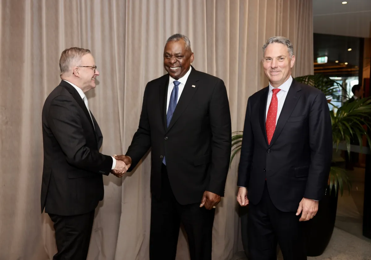 In this handout image provided by the Australian Government Department of Foreign Affairs and Trade, U.S. Defense Secretary Lloyd Austin (C) is greeted by Australian Prime Minister Anthony Albanese (L) and Australian Deputy Prime Minister and Defence Minister Richard Marles during a lunch at Persone Italian Restaurant in Brisbane, Australia, on July 28, 2023. (Sarah Friend/Australian Government Department of Foreign Affairs and Trade via Getty Images)