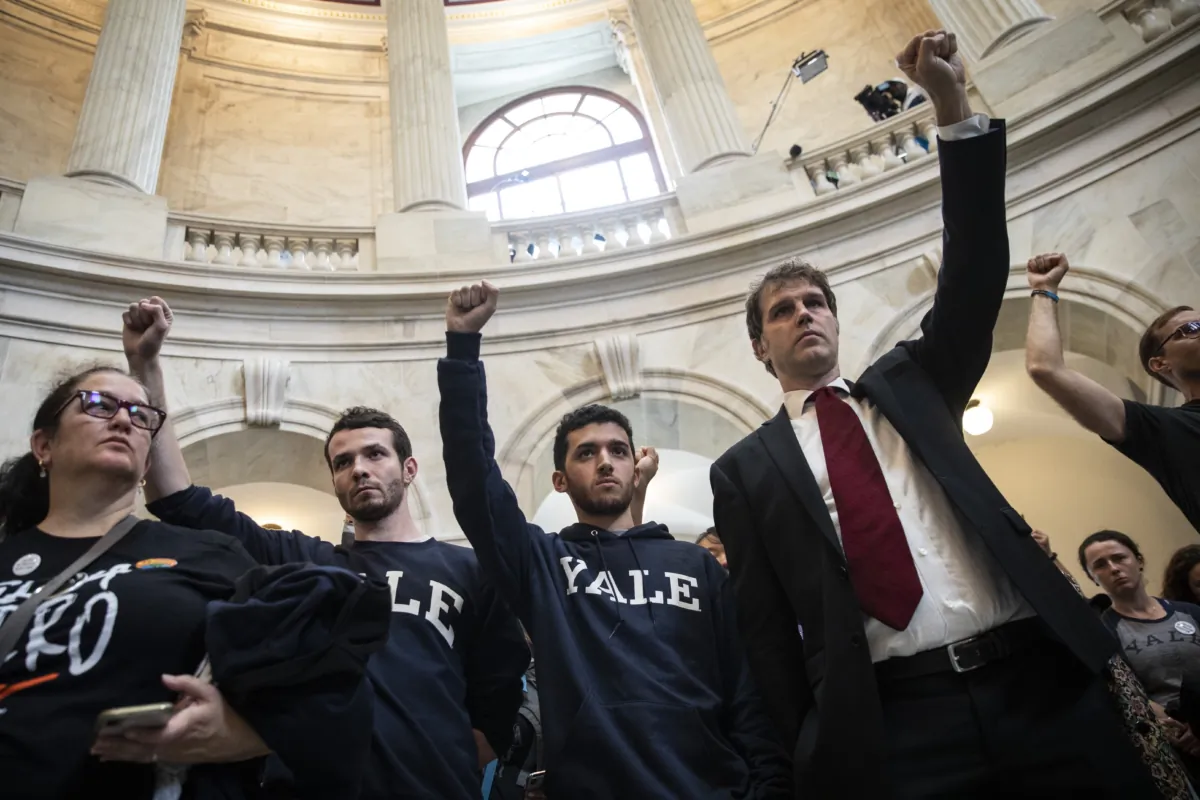 Yale University Law student Jesse Tripathi (2R) and others protest against Supreme Court nominee Brett Kavanaugh in the rotunda of the Russell Senate Office Building on Capitol Hill in Washington, on Sept. 24, 2018. (Drew Angerer/Getty Images)