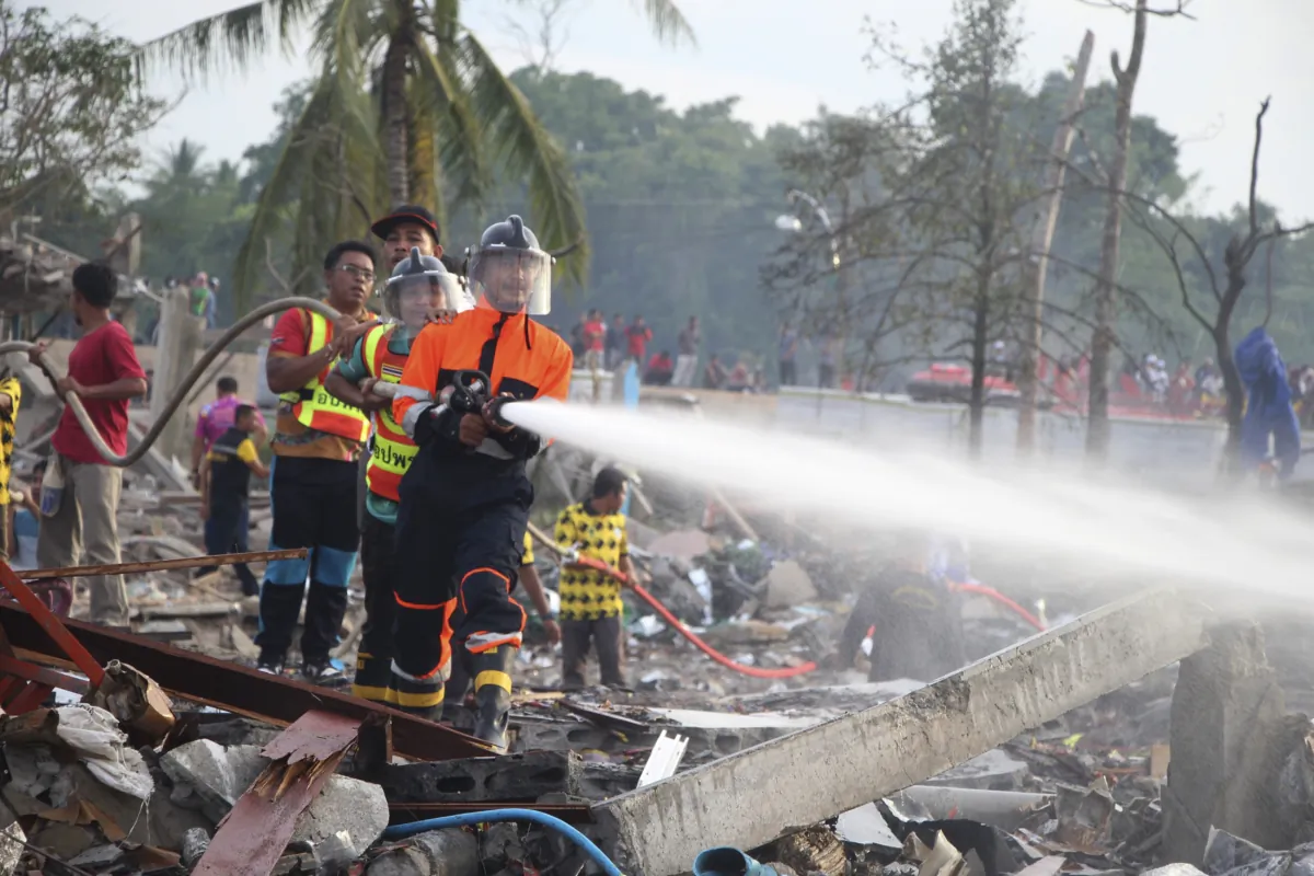 A fireman sprays water after an explosion occured at a firework warehouse in Narathiwat province southern Thailand, on July 29, 2023. (Kriya Tehtani/AP Photo)