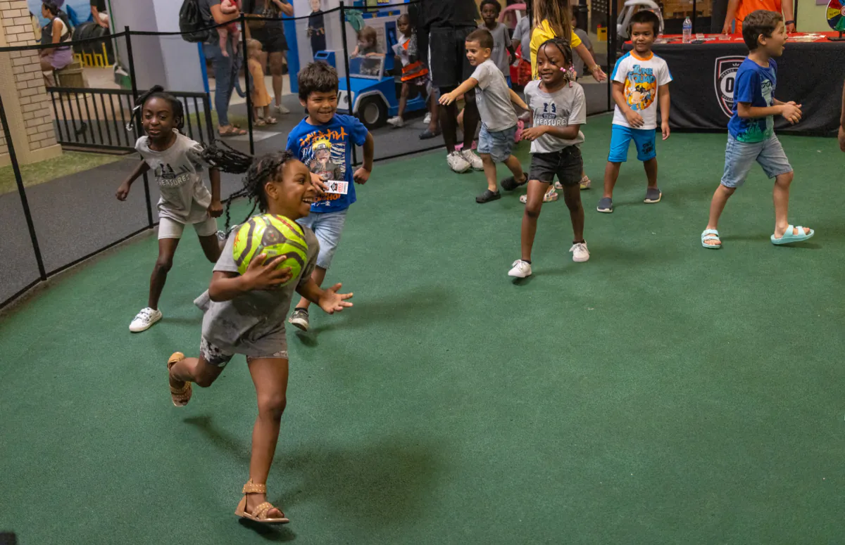 Players of the Orange County Soccer Club teach children soccer maneuvers at the Pretend City Children’s Museum in Irvine, Calif., on July 28, 2023. (John Fredricks/The Epoch Times)